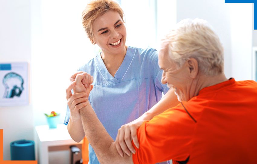 A nursing staff providing physiotherapy services to an elderly man.