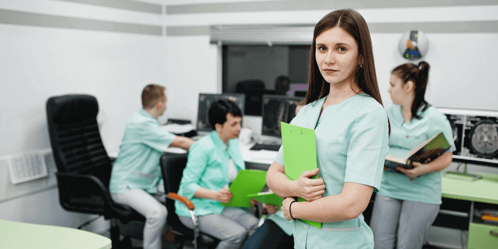 Five registered nurses within a healthcare facility working on a report.