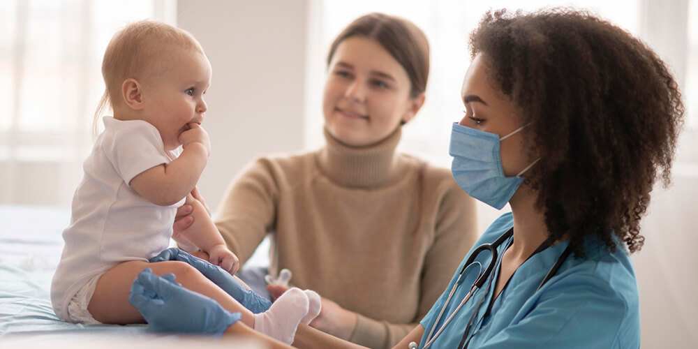 An oncology nurse holding hands of a patient providing compassionate support.