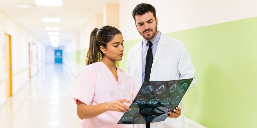 Registered general nurses (RGN) discussing a case in the hospital corridor