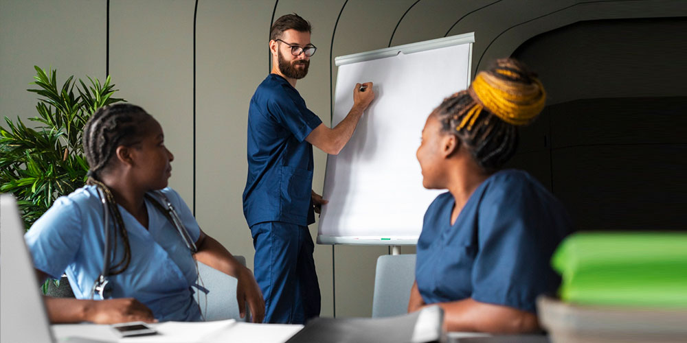 A group of nurses with a nurse manager discussing the quality of patient care