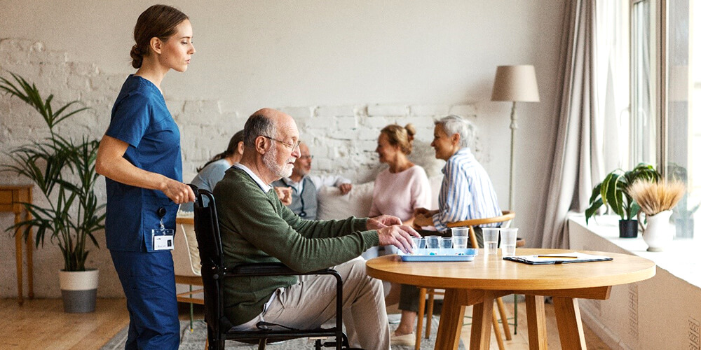 A nurse and an elderly patient read the directions on a medicine bottle.