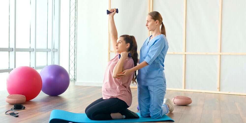 Nurse assisting to a patient in rehabilitation recovering from injury