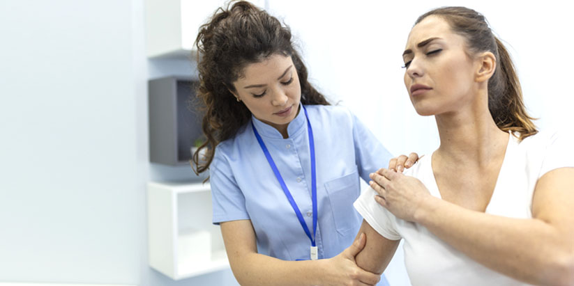 A travel nurse wearing a mask handling patient document