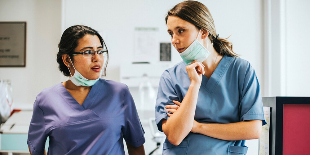 Two nurse practitioners evaluating the nursing cv of a candidate