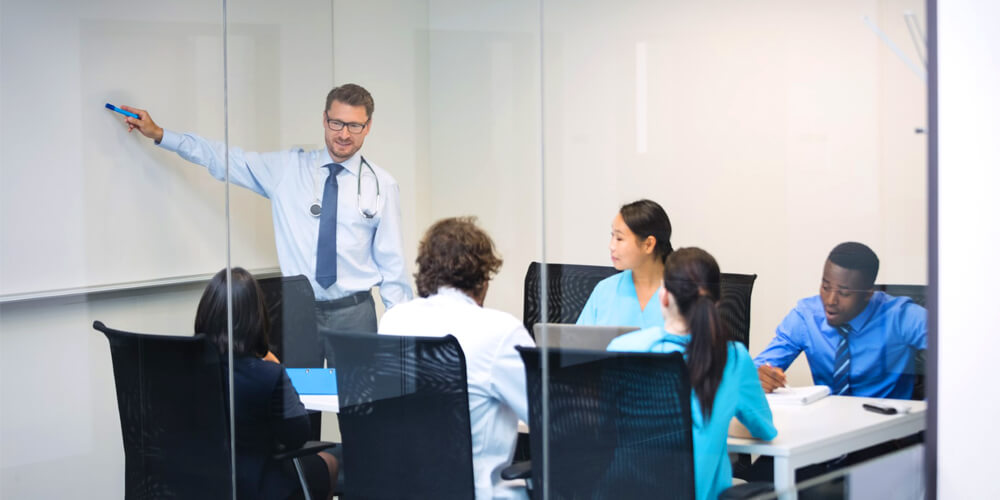 A healthcare team assessing the risk in the setting in a conference room.