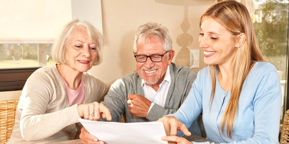 A caregiver interacts with a disabled care home resident.