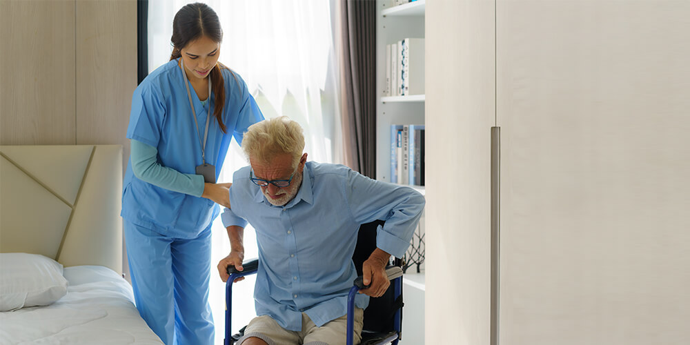 A nurse and an elderly patient read the directions on a medicine bottle.